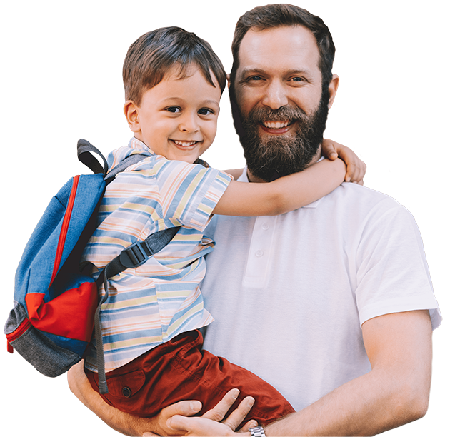 dad holding school-age son